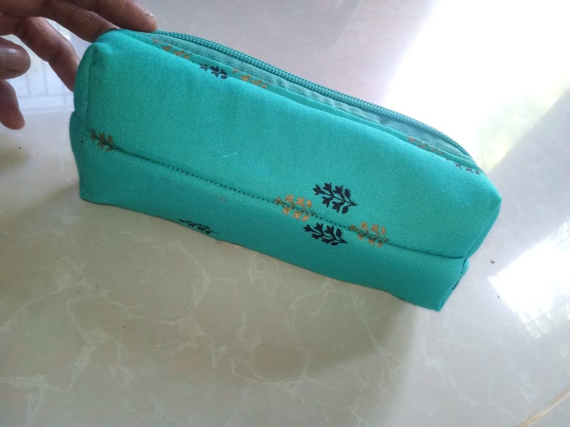 *🌸 Elegant Handcrafted Fabric Pouch*   Perfect for storing cosmetics, pens, or small essentials in style!  🧵 *Material:* Premium Cotton with Embroidery   👜 *Design:* Compact, Lightweight & Durable   🎨 *Color:* Fresh Aqua Blue with Floral Print   📐 *Use:* 